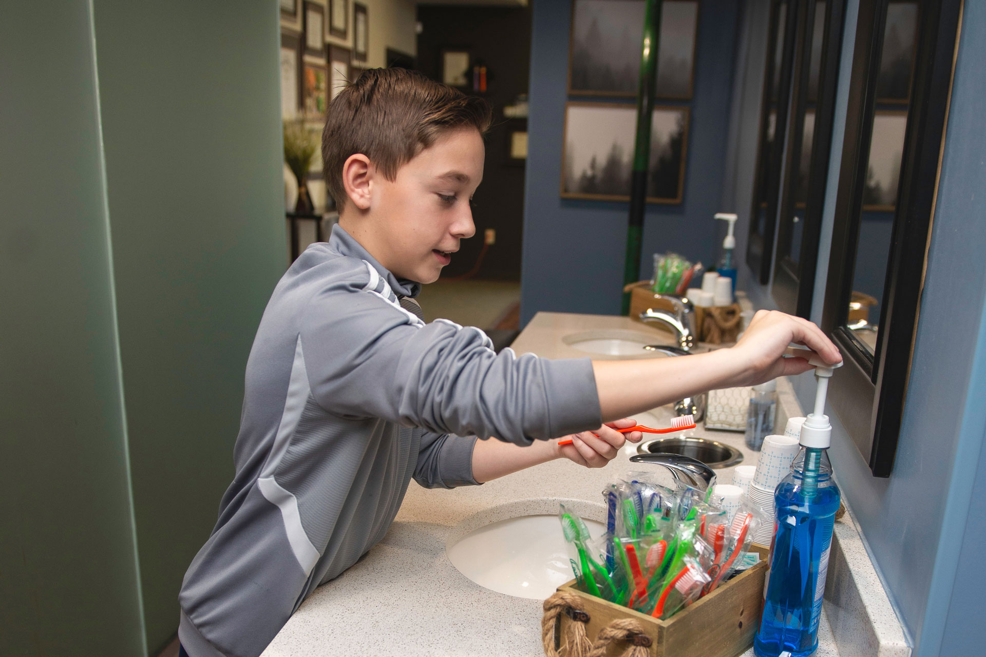 Young patient washing hands preparing for his treatment